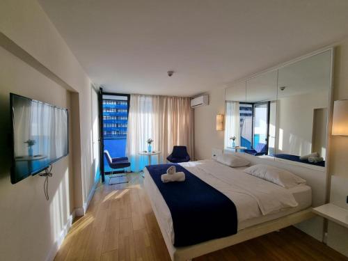 a bedroom with a large bed and two windows at VIP HOTEL Sea view in batumi R in Batumi