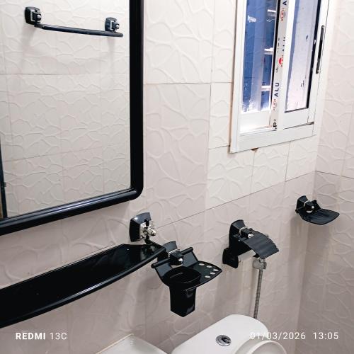 a bathroom with a sink and a mirror at Les studios meublés d'Angré in Abidjan