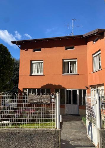 a building with a fence in front of it at CASA QUANZITO -Casa intera con giardino e parcheggio privato, ideale per famiglie in Dervio