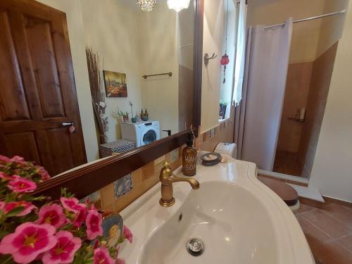 a bathroom with a sink and a mirror at Evenos Stone Villa in Ierapetra