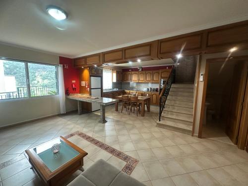 a living room with a kitchen and a dining room at The House of Passos in Ponta do Sol