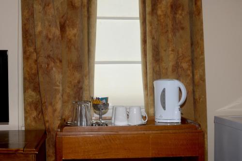 a wooden cabinet with a white appliance on top of it at Edinburgh Gallery Bed & Breakfast in Hobart