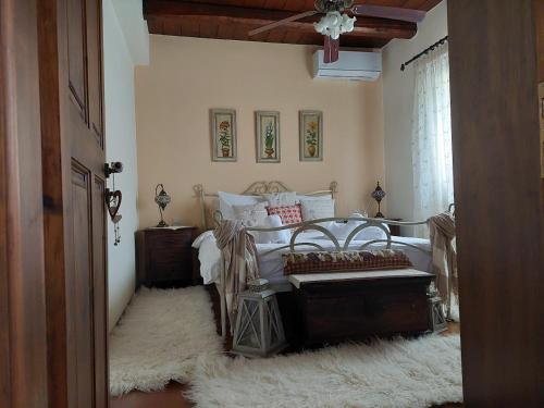 a bedroom with a bed and a white rug at Evenos Stone Villa in Ierapetra