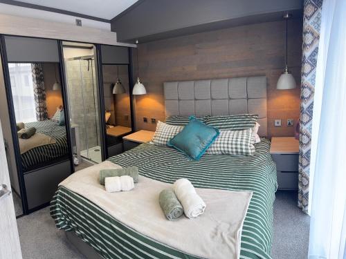 a bedroom with two beds with towels on them at Lime Tree Lodge in Crieff