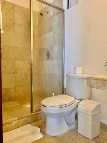 a bathroom with a toilet and a shower at Spacious 3 bedroom Condo by Mamitas beach in Playa del Carmen