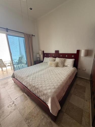 a bedroom with a large bed with pillows on it at Spacious 3 bedroom Condo by Mamitas beach in Playa del Carmen