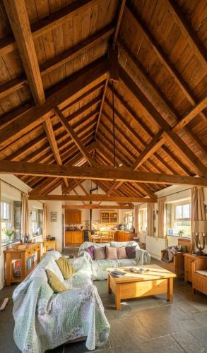 a large living room with a couch and a table at Haytor Rocks, Dartmoor escape in Bovey Tracey