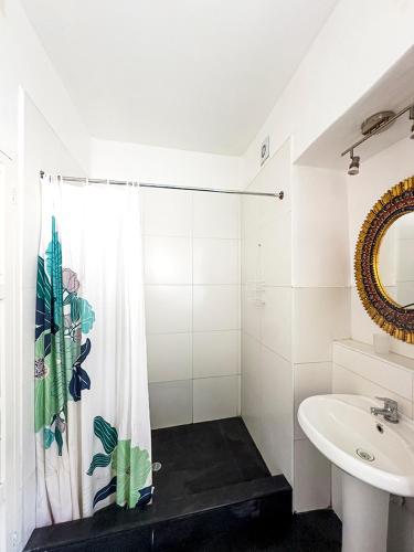 a bathroom with a shower curtain and a sink at Illa B&B in Cusco