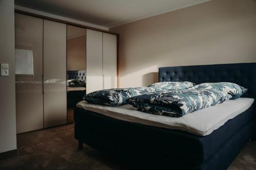 a bed with pillows on it in a bedroom at Apart Veronika Imst - Exklusiv Wohnen in Imst in Imst