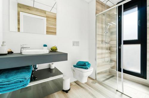 a bathroom with a shower and a sink and a toilet at Casa Phillips in Orihuela Costa