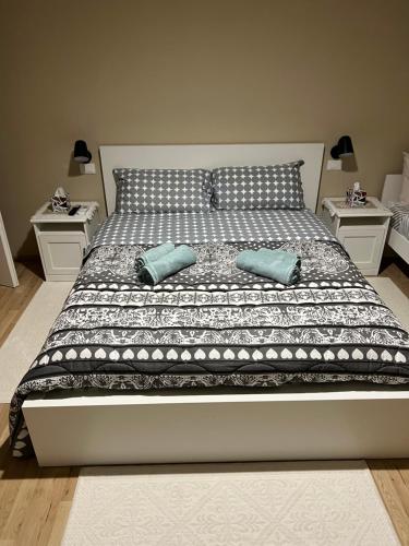 a large bed with two pillows and two night stands at Dimora Stadio Biella in Biella