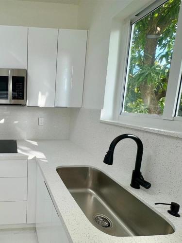a kitchen with a sink and a window at Beautiful House Near Marlins Stadium in Miami