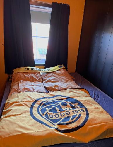 a bed with a football jersey on it at Marits residense in Kongsberg