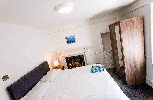 a bedroom with a bed and a fireplace at Josies House - Bright & Cozy Stay in Banff