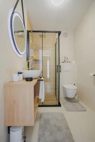 a bathroom with a sink and a toilet and a mirror at Exclusive Apartment MARIJA in Strožanac