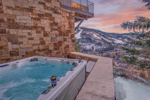 a hot tub with a view of the mountains at Radiance Retreat in Vail