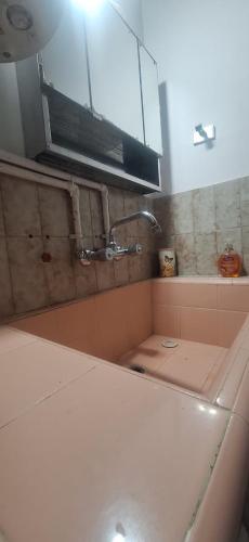 a bathroom with a sink and a mirror at Paseo Dean Funes Dúplex in San Rafael