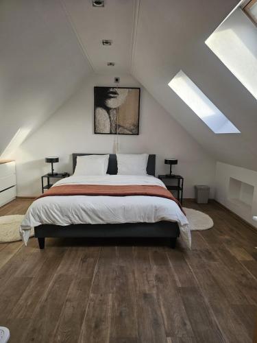 a bedroom with a large bed in a attic at Vacation at Emi's in Wetteren