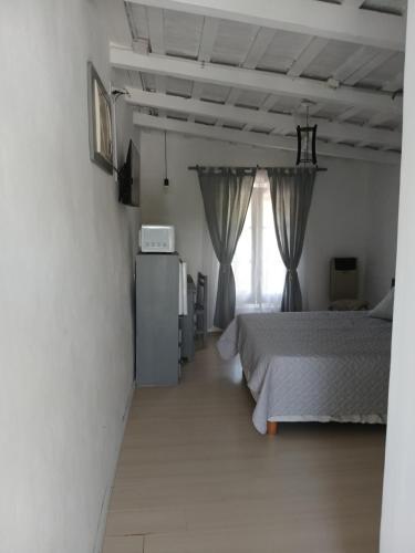 a bedroom with a bed and a window at Hospedaje Sarmiento in Carlos Casares