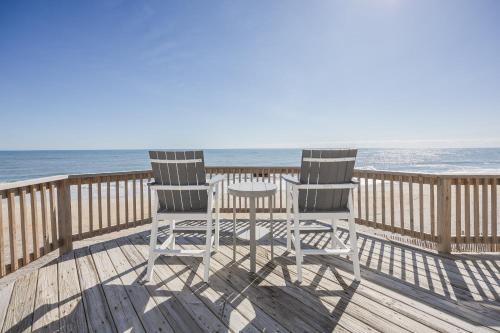 two chairs and a table on a deck overlooking the ocean at 7029 - Just Breathe in Rodanthe
