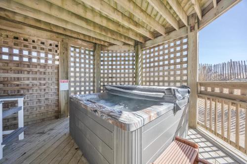 a hot tub sitting inside of a wooden house at 7029 - Just Breathe in Rodanthe
