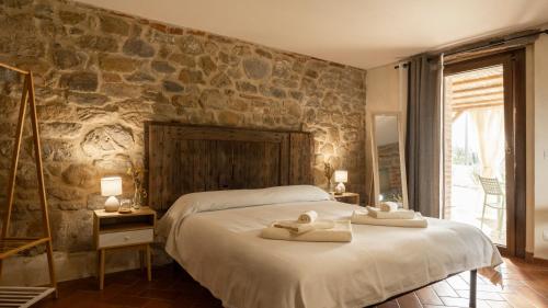 a bedroom with a large bed with towels on it at Agriturismo L'Accolta in Tuoro sul Trasimeno