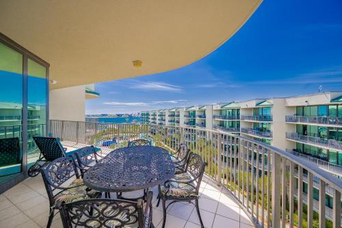 a patio with a table and chairs on a balcony at Phoenix on the Bay 1524 in Orange Beach