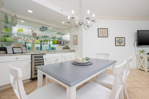 a kitchen with a table and chairs and a counter at Phoenix on the Bay 1524 in Orange Beach