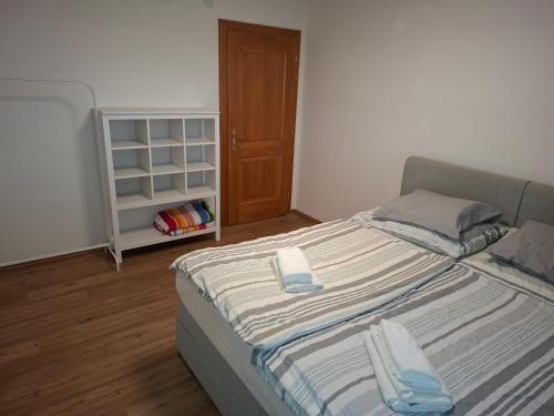 a bedroom with a large bed with a book shelf at Bed&Breakfast bei Sabine in Leutschach