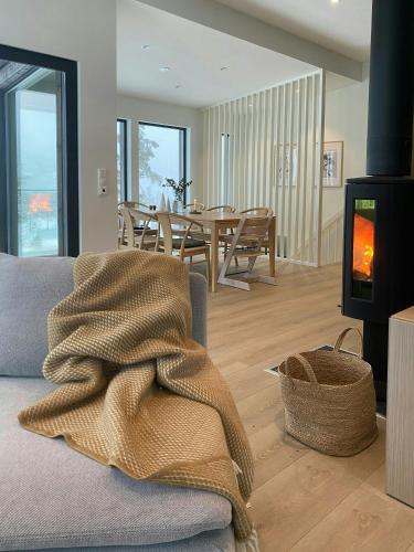 a living room with a couch and a fireplace at Spacious Mountain Cabin With View In Nissedal in Treungen