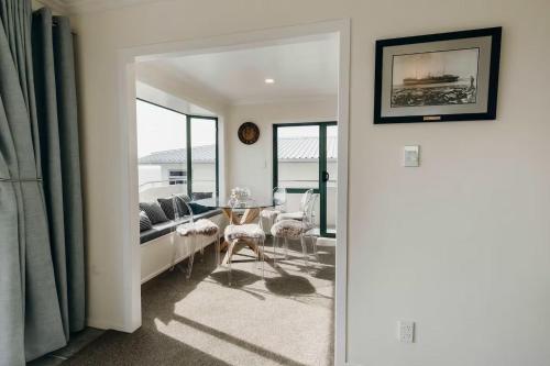 a living room with a couch and a table at Oceanfront Retreat - Beach Access - 2BR Bell Block in New Plymouth
