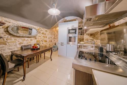 a kitchen with a table and a counter top at Alternative Medieval Villa in Kalamoti