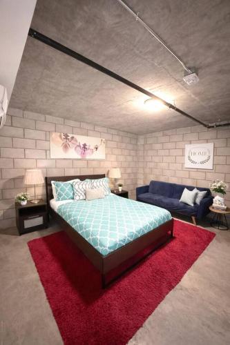 a bedroom with a bed and a red rug at CasaViva Loft - Modern 2BR with Garage Parking, In-Unit Washer Dryer & ADA Access - Walk to Hillcrest, 5 Min to Gaslamp & North Park in San Diego
