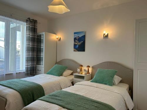 two beds sitting next to each other in a room at Europe's last sunset in Waterville