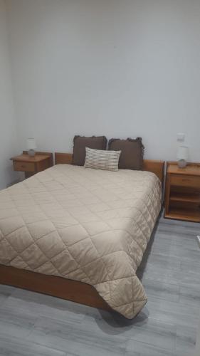a bed in a bedroom with two night stands at Segredo do Lago in Monsaraz