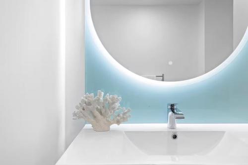 a bathroom with a sink and a mirror at Beachfront Studio - Ocean Views - Bell Block in New Plymouth