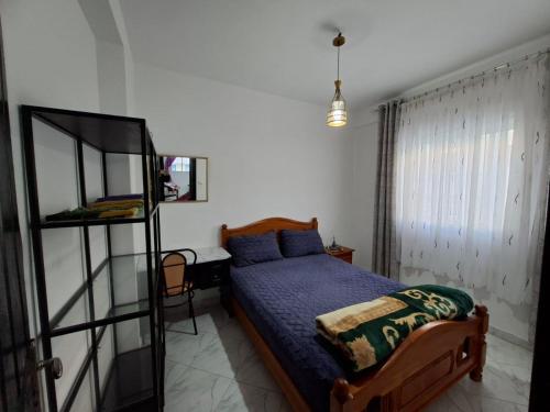 a bedroom with a bed and a desk and a mirror at RESIDENCE AL Hoceima 2 Minutes de prés de PLAGE CALABONITA in Al Hoceïma