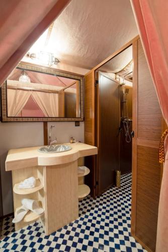 a bathroom with a sink and a mirror at Best Classic Sahara Experiences in Merzouga