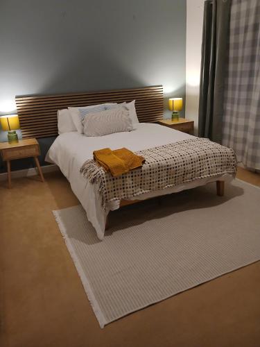 a bedroom with a bed with two towels on it at Modern Coastal Haven Family and Dog friendly in Burry Port