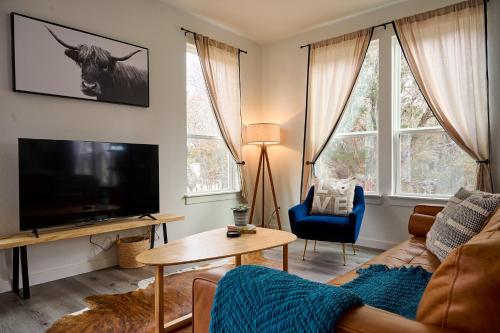 a living room with a couch and a tv at A Stunning Escape in Canyon Lake
