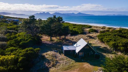 an aerial view of a small house on the beach at The Dunes Hideaway in Dolphin Sands