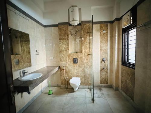 a bathroom with a sink and a toilet at Remix stays in Gurgaon