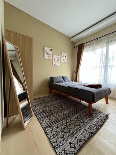 a bedroom with a bunk bed and a rug at Menata Villa Harmoni in Pakem