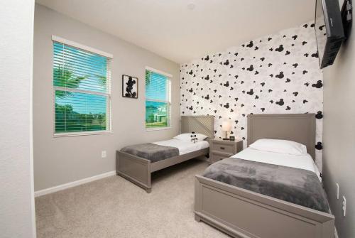 a bedroom with two beds and a wall with bats at Cozy 4BR Villa w Private Pool Spa Near Disney in Kissimmee