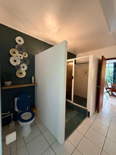 a bathroom with a blue toilet and a shower at Plage privée - Vahine Ori Lodge in Raiatea