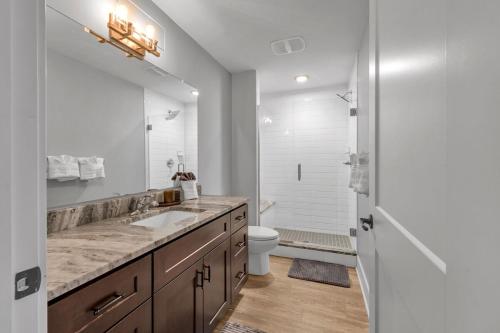 a bathroom with a sink and a toilet and a mirror at Modern Birmingham Retreat in Birmingham