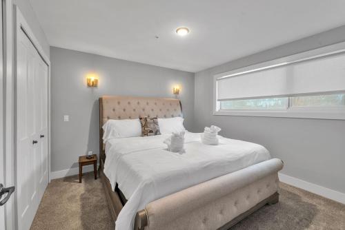 a bedroom with a large white bed with a window at Modern Birmingham Retreat in Birmingham