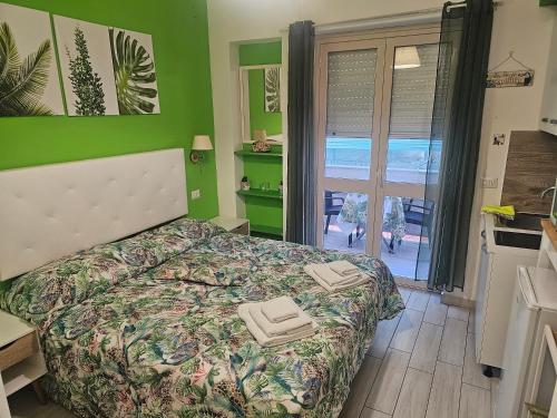a bedroom with a bed with towels on it at ele&gio accomodation - Sea View in Tropea