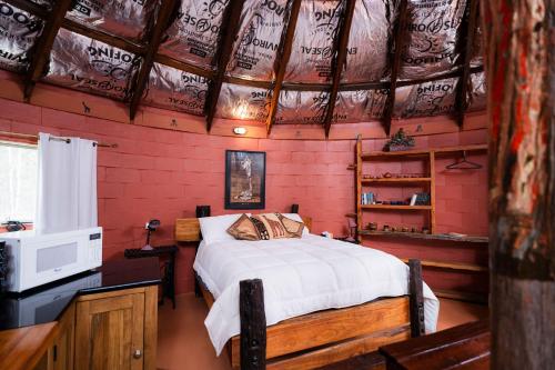 a bedroom with a bed in a red room at Rileysview in Kilcoy