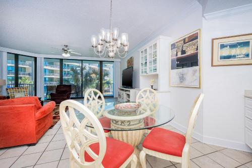 a living room with a table and chairs at Phoenix on the Bay 1213 in Orange Beach